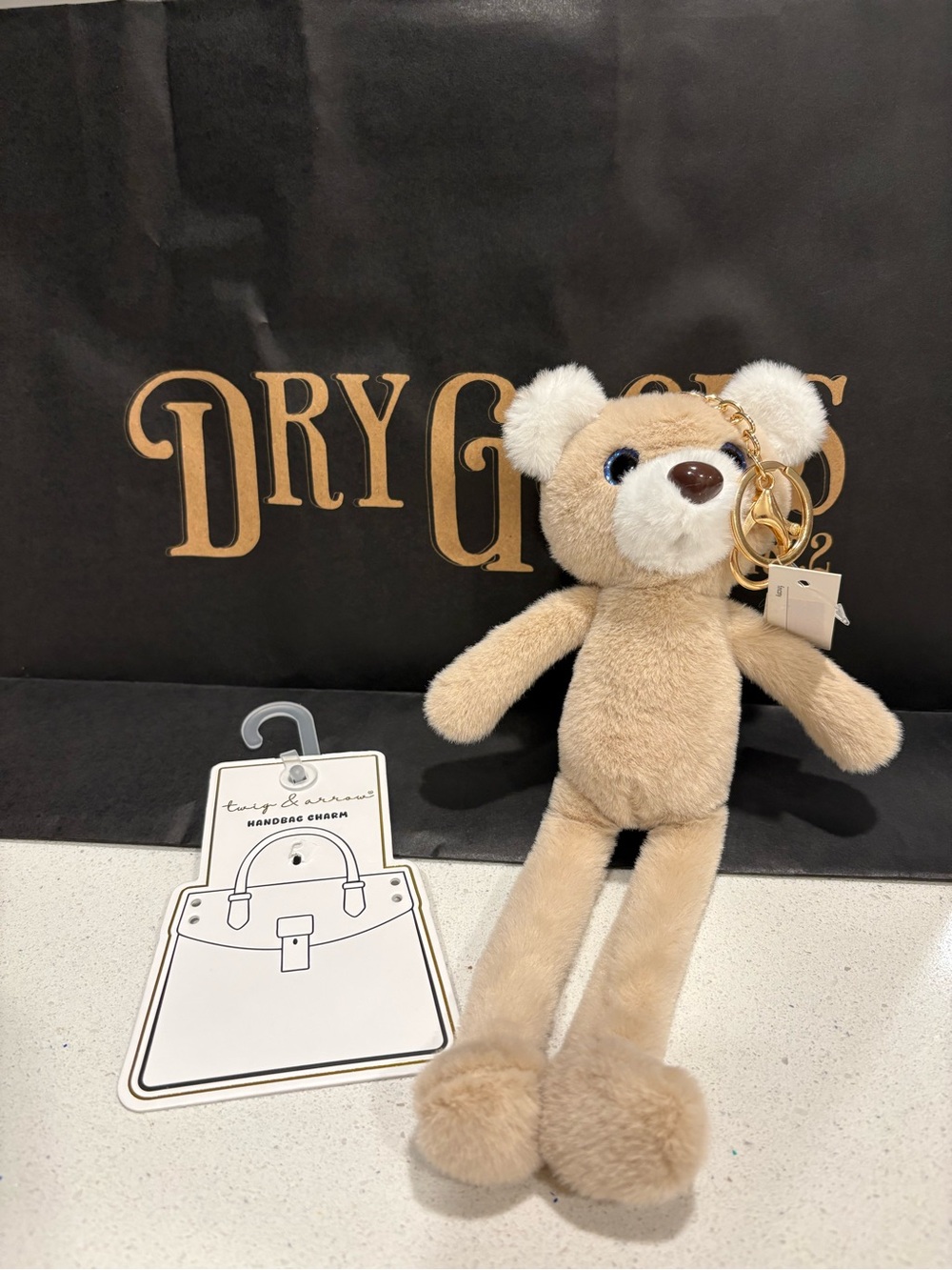 Dry Goods Beige Plush Bear Bag Charm with Gold Hardware and Pom-Pom Feet